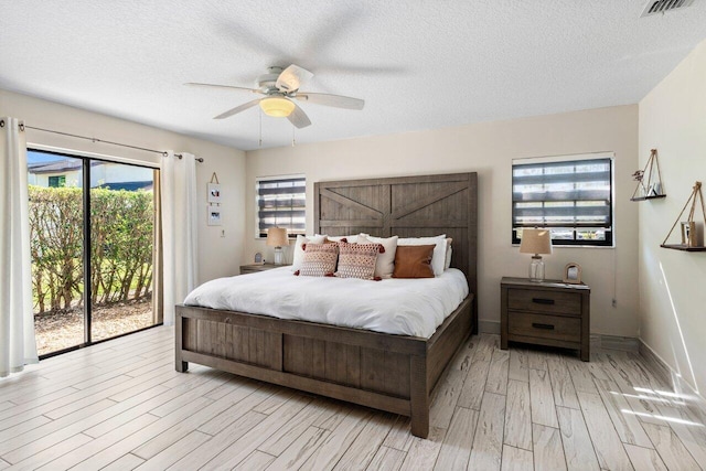 bedroom featuring light wood-type flooring, a textured ceiling, access to exterior, and a ceiling fan