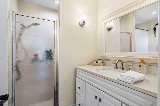 full bath featuring vanity and a shower stall