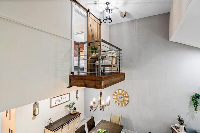 interior space with a barn door and a chandelier