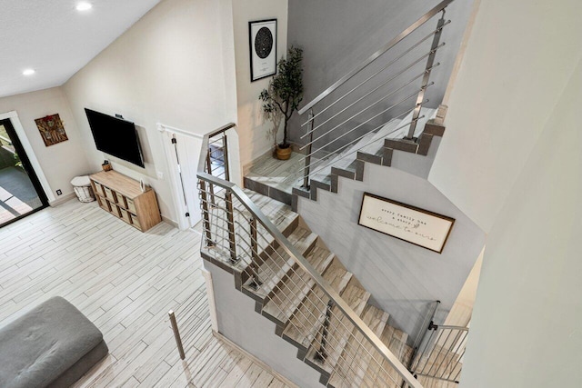 stairway featuring recessed lighting, baseboards, and wood finished floors