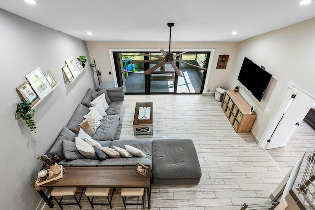 living room featuring recessed lighting, baseboards, and wood finished floors