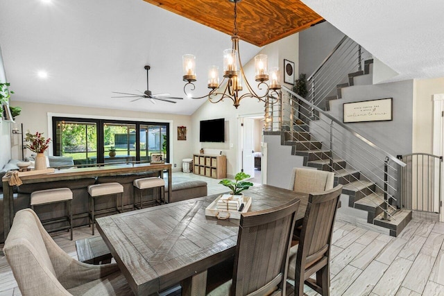 dining room with lofted ceiling, stairway, light wood-style flooring, and ceiling fan