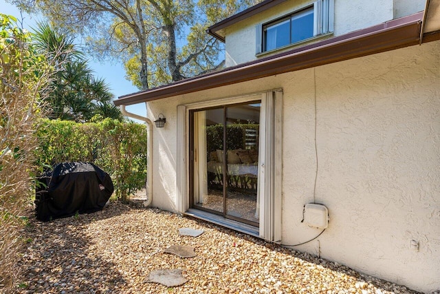 entrance to property with stucco siding