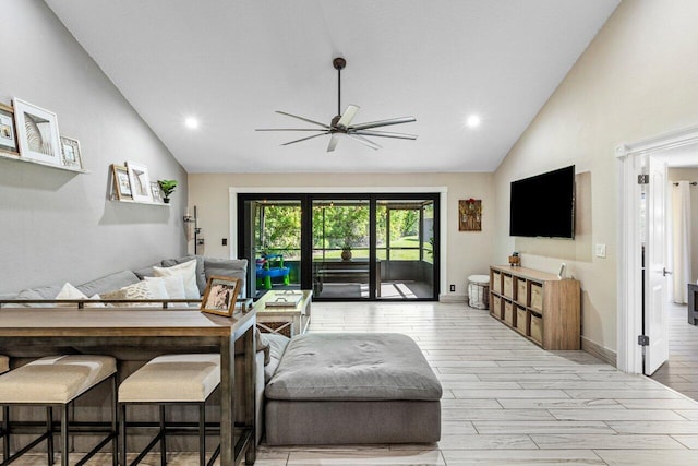 living area with vaulted ceiling, wood finished floors, and ceiling fan