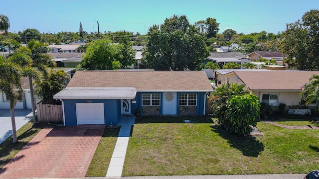 ranch-style home featuring stucco siding, decorative driveway, fence, an attached garage, and a front yard