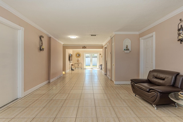 hallway featuring light tile patterned flooring, french doors, baseboards, and ornamental molding