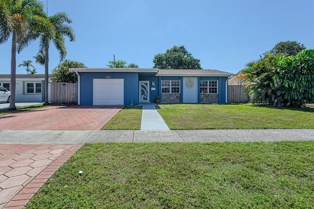 single story home featuring a front yard, fence, an attached garage, stucco siding, and decorative driveway