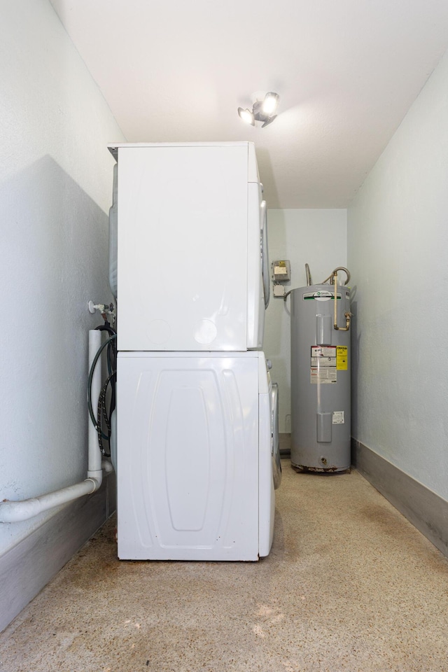 utilities with electric water heater and stacked washing maching and dryer