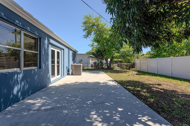 view of patio / terrace featuring french doors, central AC unit, and a fenced backyard