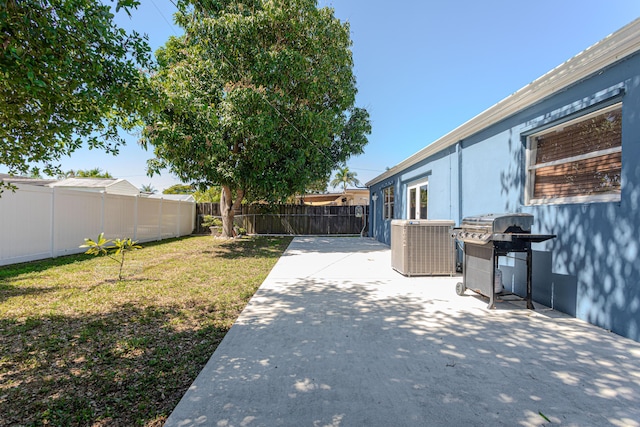 view of yard with a patio, cooling unit, and a fenced backyard