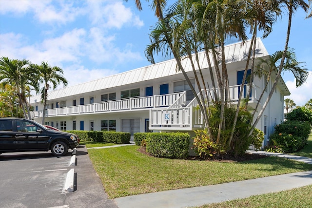 view of building exterior with uncovered parking