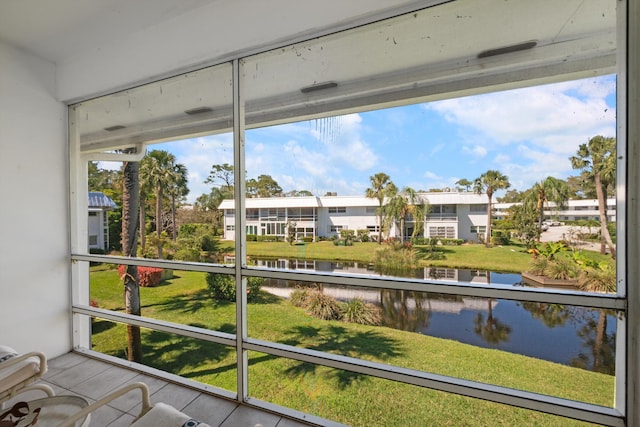 unfurnished sunroom with a water view