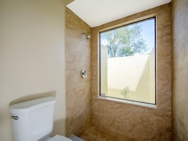 bathroom featuring toilet and tiled shower