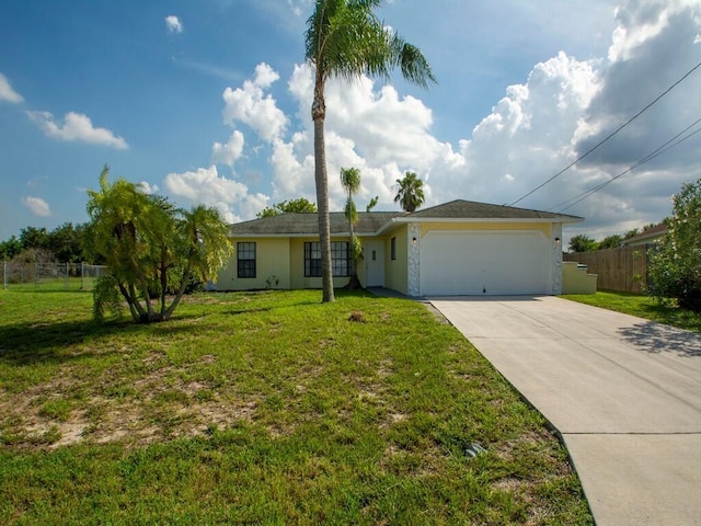 ranch-style home with a front yard, fence, driveway, stucco siding, and a garage