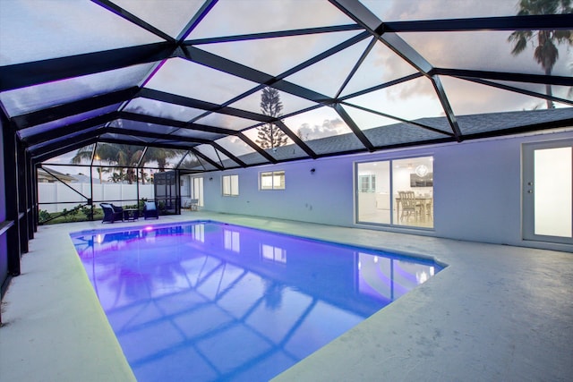 view of swimming pool with a lanai, a fenced in pool, and a patio