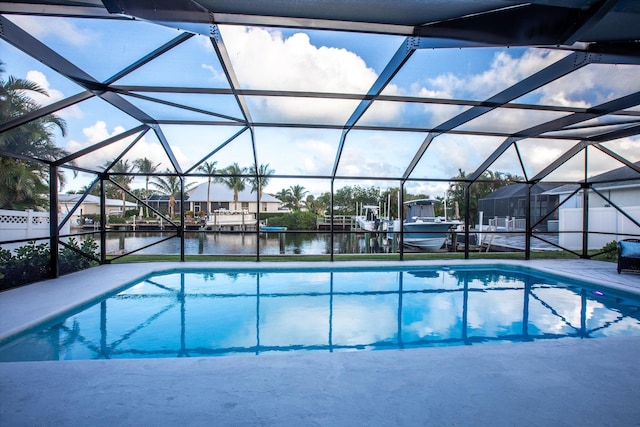 pool featuring glass enclosure and a water view