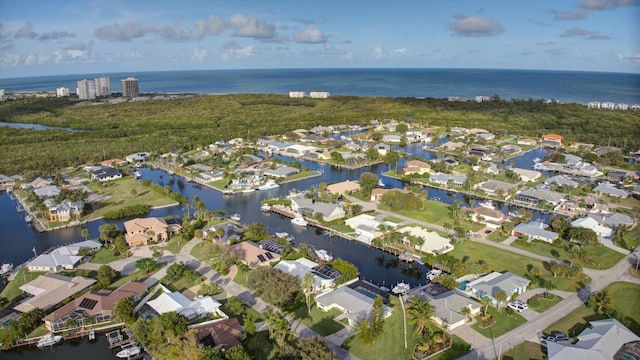 birds eye view of property with a water view and a residential view