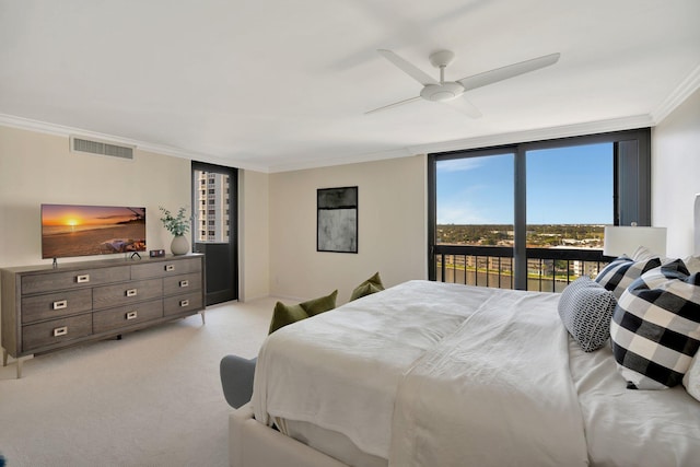 bedroom with visible vents, light colored carpet, expansive windows, ornamental molding, and a ceiling fan