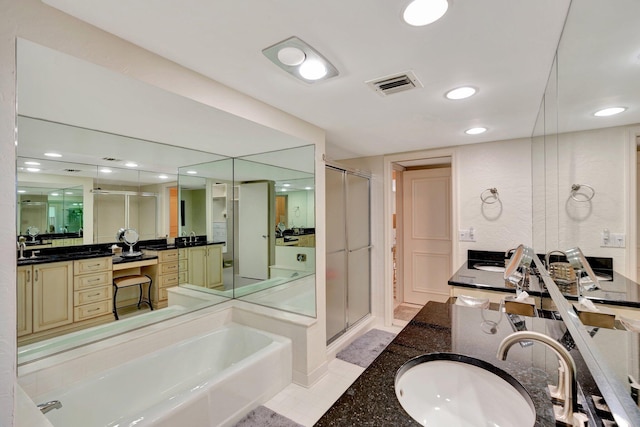 full bathroom with vanity, a bath, visible vents, and a stall shower