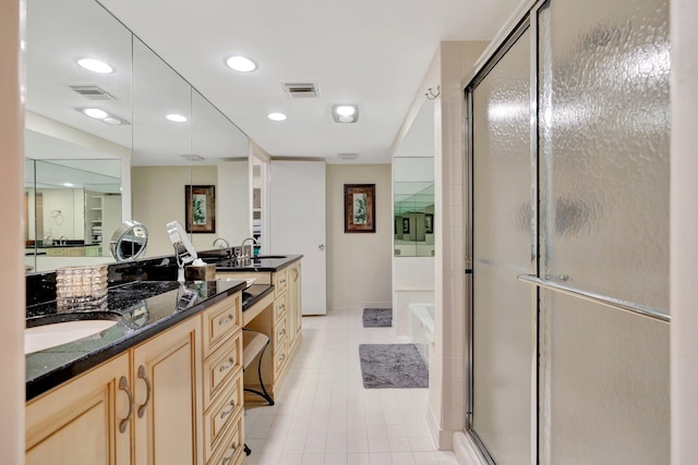 bathroom featuring visible vents, double vanity, a stall shower, a sink, and a bath