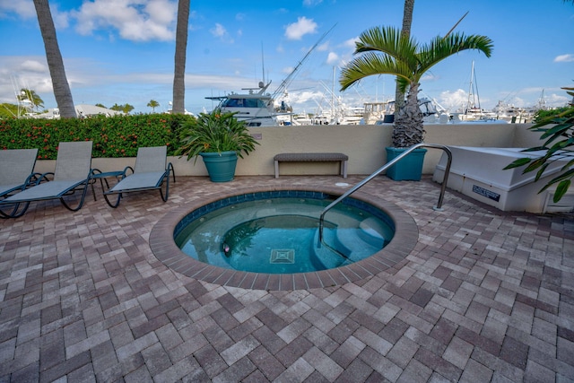 view of pool featuring a community hot tub and a patio