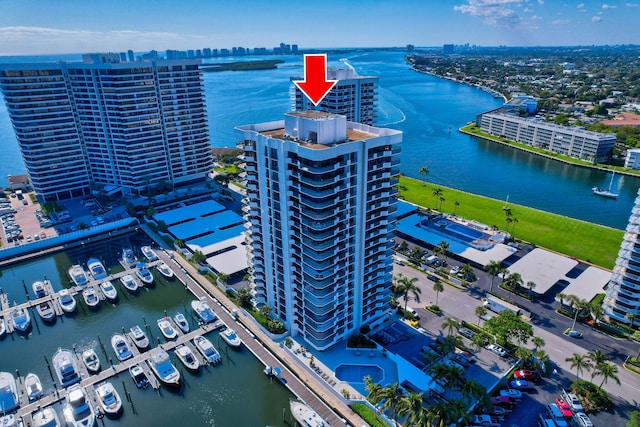 birds eye view of property featuring a city view and a water view