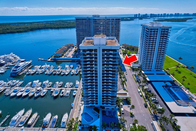 birds eye view of property featuring a city view and a water view