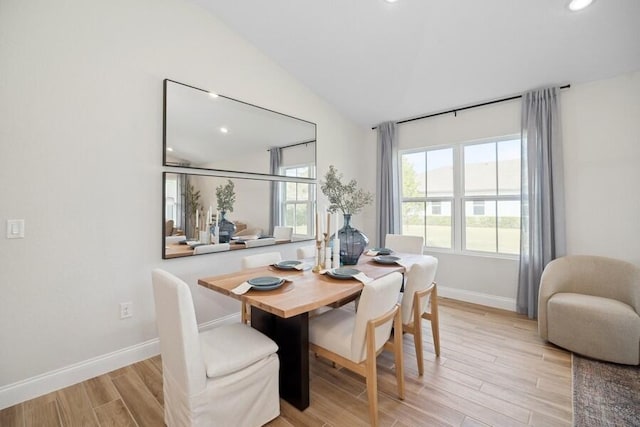 dining area featuring recessed lighting, light wood-type flooring, lofted ceiling, and baseboards