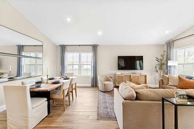 living room featuring recessed lighting, light wood-type flooring, baseboards, and vaulted ceiling