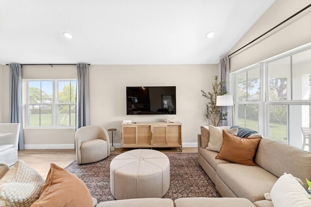 living room with recessed lighting, lofted ceiling, baseboards, and wood finished floors