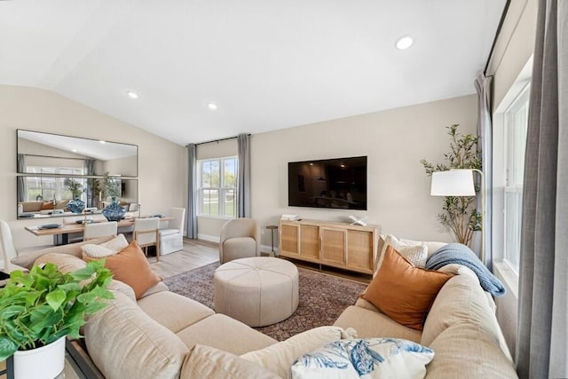 living area with recessed lighting, baseboards, lofted ceiling, and wood finished floors