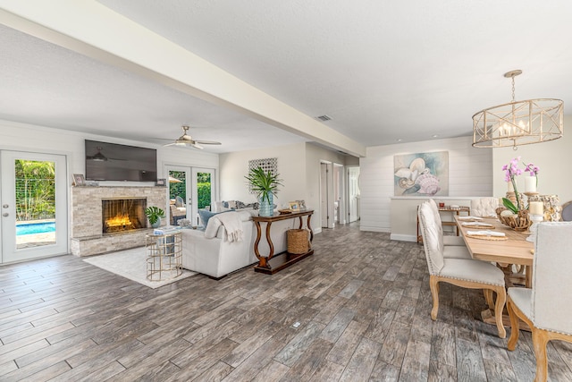 living room featuring visible vents, a healthy amount of sunlight, wood finished floors, and french doors