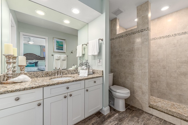 ensuite bathroom featuring visible vents, toilet, ensuite bath, walk in shower, and vanity