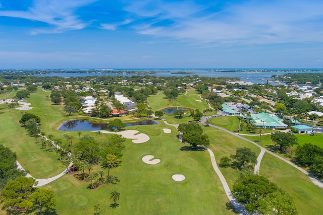 drone / aerial view with a water view and view of golf course