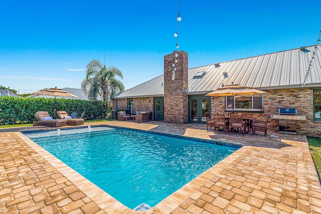 view of swimming pool with a patio, a fenced in pool, area for grilling, french doors, and an outdoor hangout area