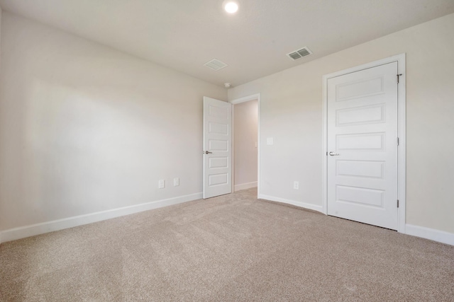 unfurnished bedroom featuring visible vents, baseboards, and carpet