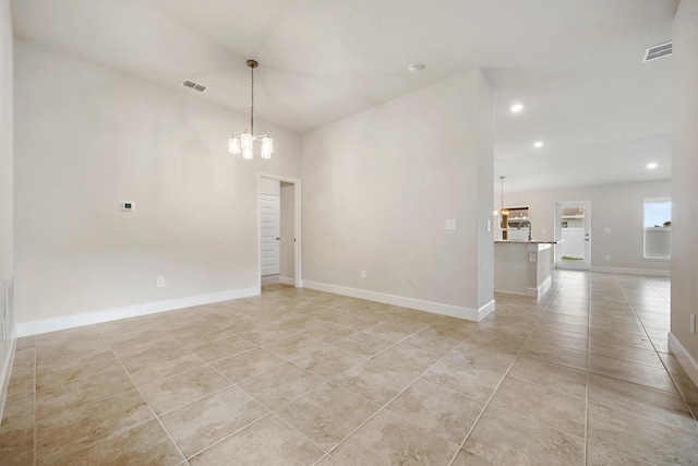 empty room with light tile patterned floors, visible vents, baseboards, and an inviting chandelier