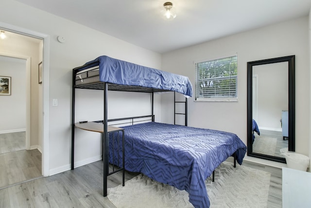 bedroom featuring wood finished floors and baseboards