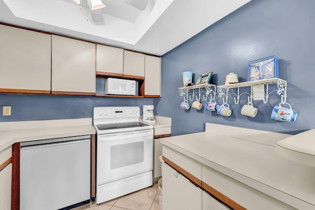 kitchen featuring ceiling fan, light countertops, light tile patterned floors, white appliances, and white cabinetry