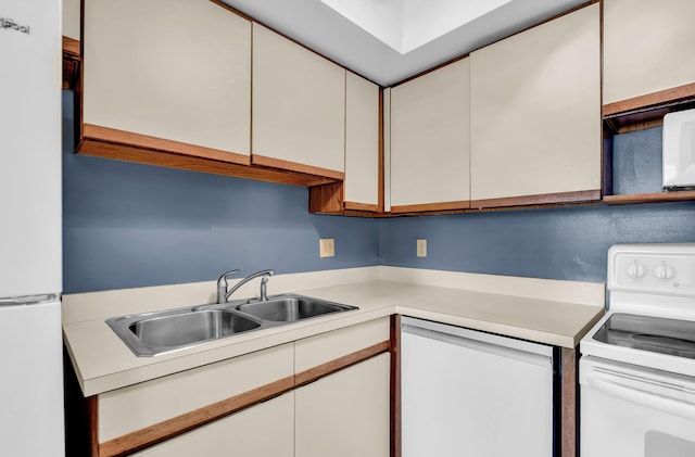 kitchen with white cabinetry, white appliances, light countertops, and a sink