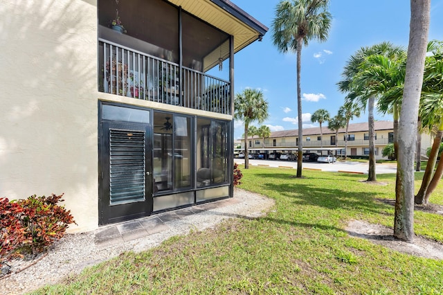 exterior space featuring a lawn and stucco siding