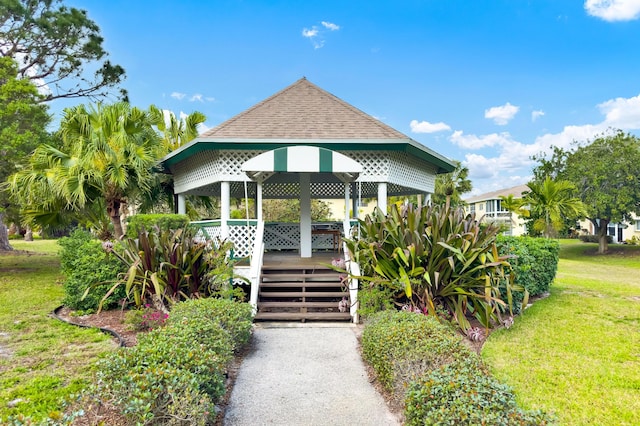 view of front facade featuring a gazebo, a front lawn, and a shingled roof