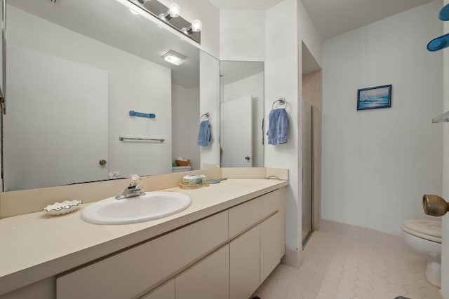 bathroom featuring vanity, baseboards, tile patterned flooring, a shower stall, and toilet