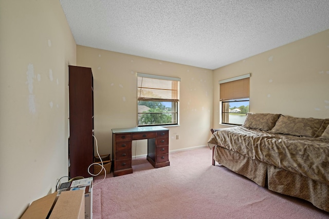 bedroom with baseboards, a textured ceiling, and carpet flooring