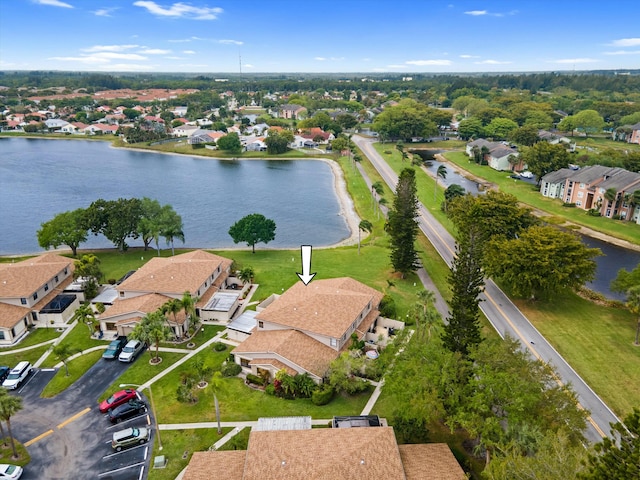 drone / aerial view featuring a residential view and a water view