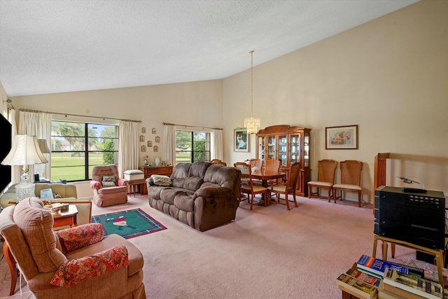 living room with a textured ceiling, high vaulted ceiling, carpet floors, and a chandelier