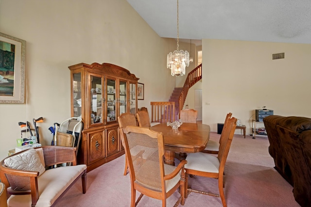 carpeted dining space with stairs, an inviting chandelier, visible vents, and high vaulted ceiling