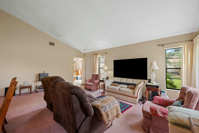 carpeted living area with visible vents and vaulted ceiling