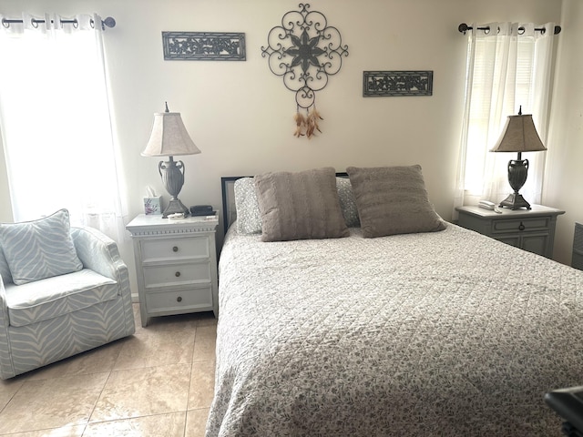 bedroom with light tile patterned flooring and multiple windows