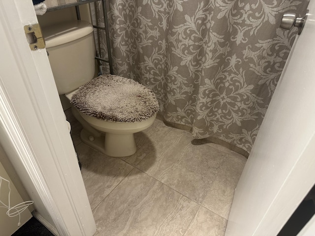 bathroom with tile patterned floors and toilet